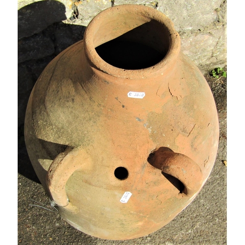 2092 - An old terracotta oviform tapered jar with two moulded loop handles, pierced hole and drawn neck, 62... 