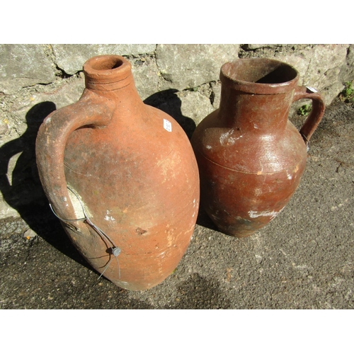 2096 - An old matt glazed terracotta jug with moulded loop handle and simple incised detail, 33cm high, tog... 