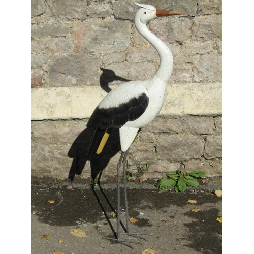 2103 - A painted sheet tin garden ornament in the form of a standing crane or heron, 98cm high