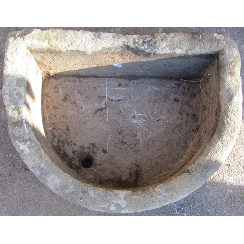 2107 - A weathered natural stone D shaped trough with drainage hole, 62cm wide x 47cm deep x 22cm high