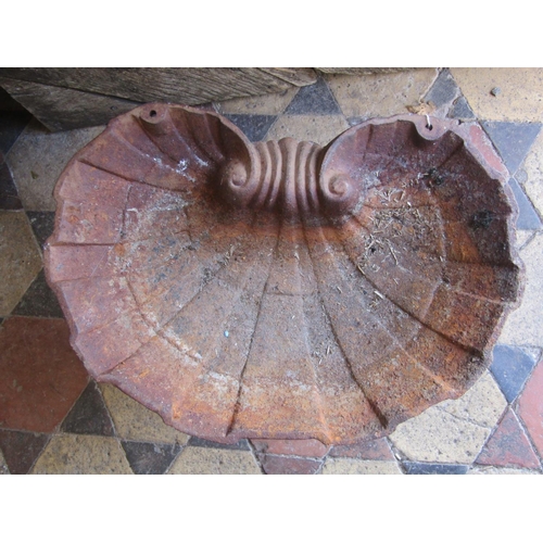 2130 - A small weathered cast iron shell shaped bird bath raised on a pierced base, 30 cm high