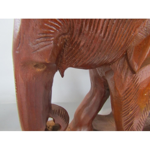 1703 - A large carved wooden elephant, a leather clad model of an elephant, a model flintlock pistol, a cop... 
