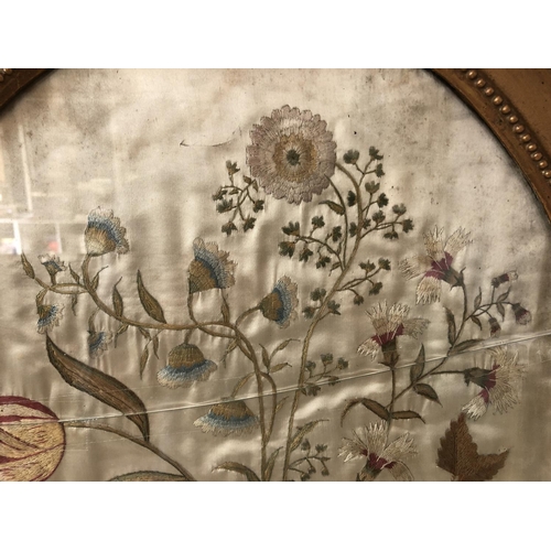 81 - Silk embroidery depicting a basket of flowers on cream silk satin (19th century or earlier) oval fra... 