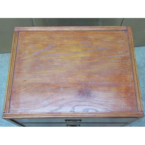 2218 - A stained oak low chest of three long graduated drawers, 54 cm wide x 42 cm deep x 59 cm high