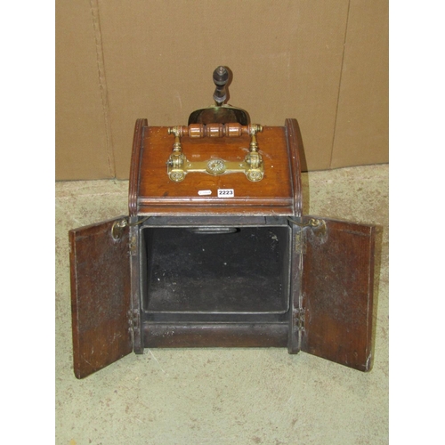 2223 - A late Victorian oak coal scuttle with patent handle and enclosing a pair of doors overlaid in decor... 