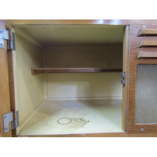 2228 - A vintage oak veneered kitchen cabinet freestanding and enclosed by an arrangement of cupboards and ... 