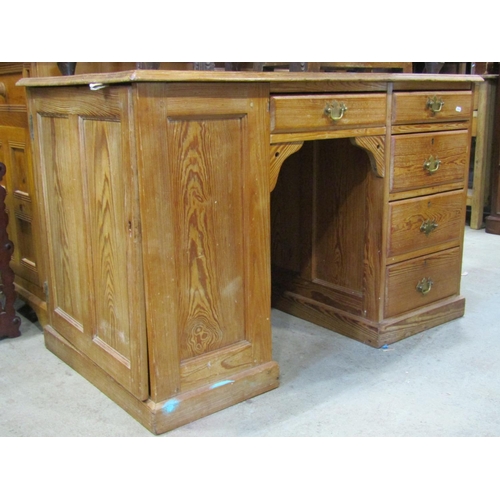 2235 - A pitch pine kneehole twin pedestal desk fitted with five drawers within a panelled framework, left ... 