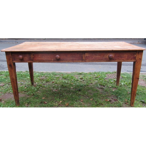 2244 - A 19th century stripped pine farmhouse kitchen table of rectangular form over three frieze drawers, ... 