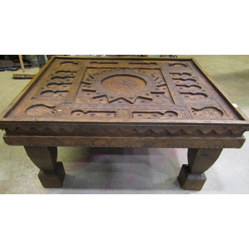 2247 - A low Eastern occasional table of rectangular form with carved sun, geometric and further detail, 85... 