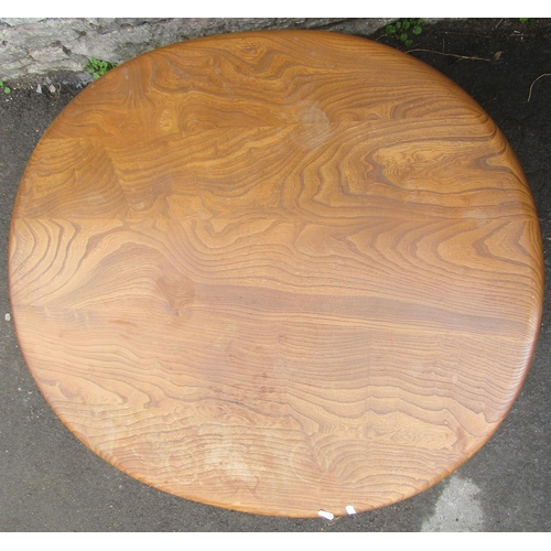 2255 - A vintage Ercol elm and beechwood occasional table of oval form raised on simple turned tapered legs... 