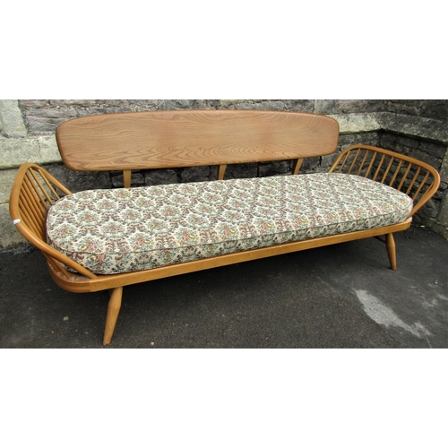 2258 - A vintage light Ercol sofa bed with shaped elm panelled back, beechwood frame with loose seat cushio... 