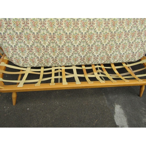 2258 - A vintage light Ercol sofa bed with shaped elm panelled back, beechwood frame with loose seat cushio... 