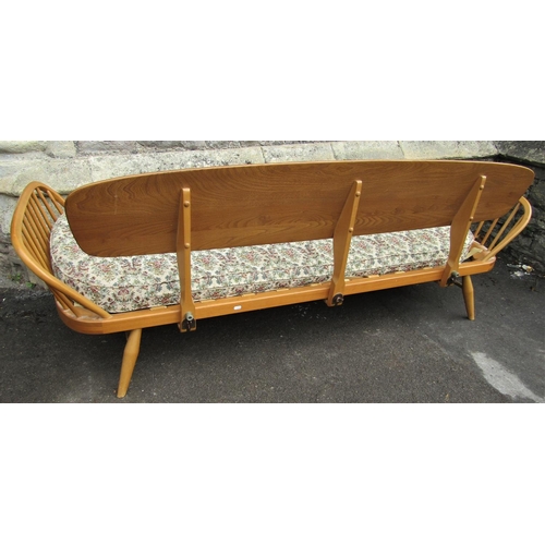 2258 - A vintage light Ercol sofa bed with shaped elm panelled back, beechwood frame with loose seat cushio... 