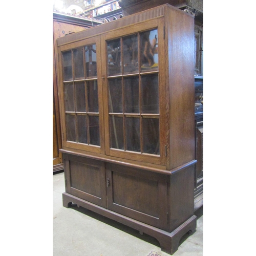 2262 - An early 20th century oak side cabinet, freestanding and enclosed by two pairs of panelled doors, th... 