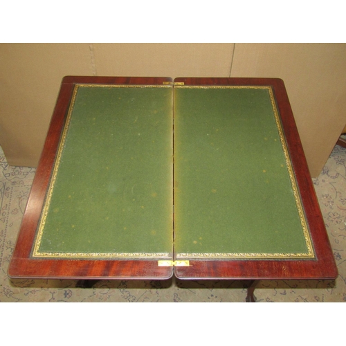 2279 - An Edwardian mahogany fold over top card table of rectangular form raised on scrolled cabriole suppo... 