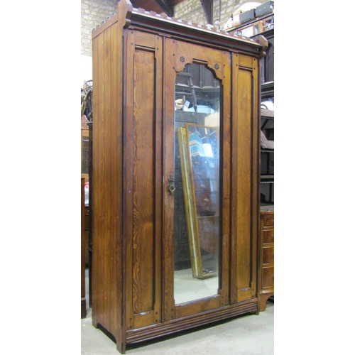 2283 - A Victorian gothic revival pitch pine wardrobe with inlaid detail, enclosed by full length central m... 