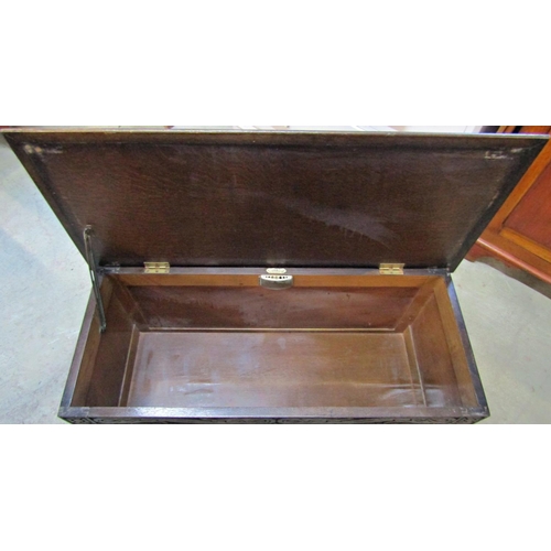 2287 - A reproduction old English style oak coffer with hinged lid and carved detail, front elevation with ... 