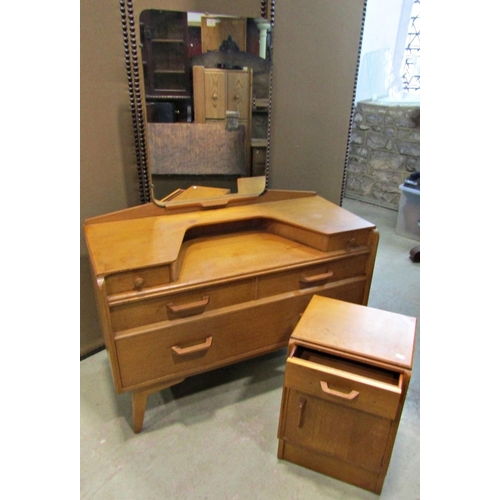 2308 - An E Gomme light oak dressing table fitted with five drawers together with a matching bedside cupboa... 