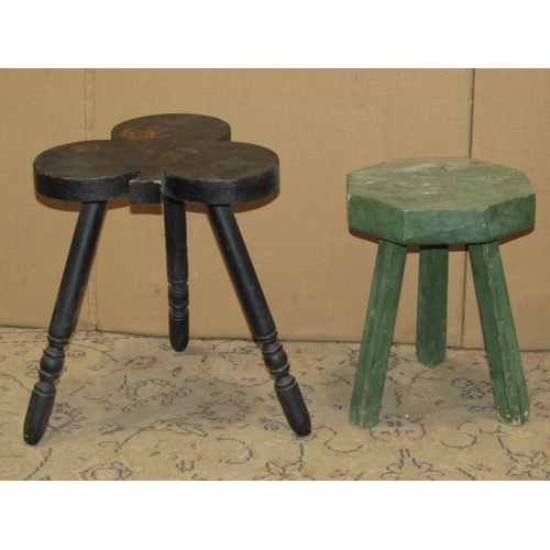 2314 - A country made three legged stool with green painted finish, together with a further ebonised stool ... 