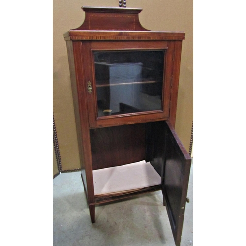 2317 - An inlaid Edwardian mahogany side/music cabinet enclosed by two panelled doors, the upper glazed, to... 