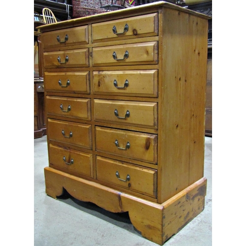 2325 - A stripped and waxed pine chest fitted with a side by side arrangement of twelve frieze drawers set ... 