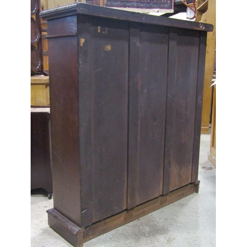 2327 - A Victorian oak floorstanding open bookcase with two adjustable shelves, repeating carved foliate de... 