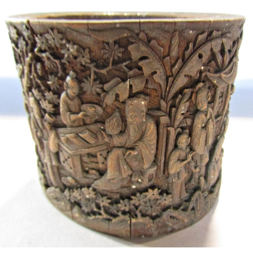1687 - A Chinese bamboo brush pot intricately carved with everyday domestic scenes, 10cm high x 12.5cm wide... 