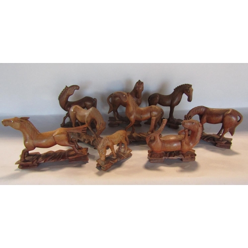 1691 - A group of nine vintage carved wood Chinese horses with beaded eyes each approximately 10cm wide.