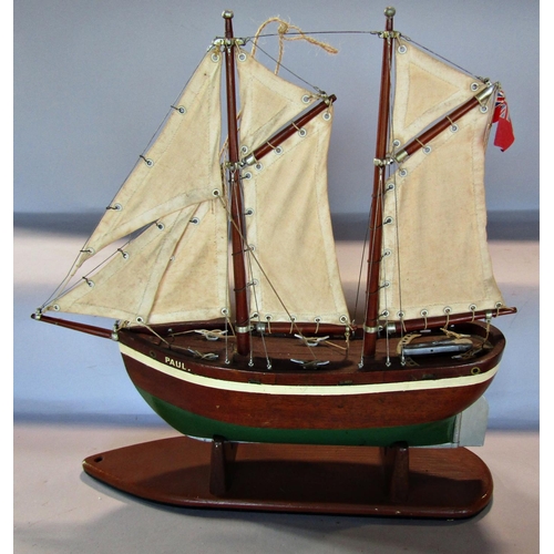 1711 - A wooden model of a two masted fishing boat, simply named Paul, on a wooden stand. 48cm max high x 4... 