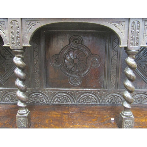 2640 - A Victorian gothic revival oak side cupboard, with panelled doors, open tiered shelves and geometric... 