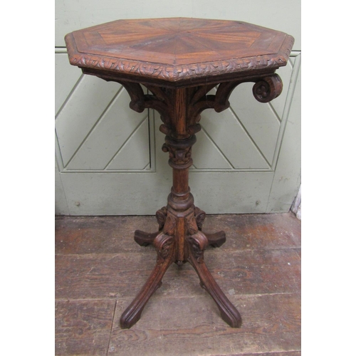 2654 - A Victorian gothic revival octagonal occasional table, the top inlaid with mahogany, with carved col... 