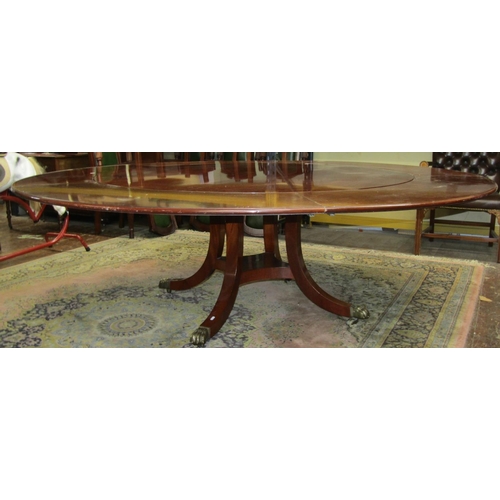 2656 - A good quality mahogany reproduction circular extending dining table, raised on swept supports with ... 