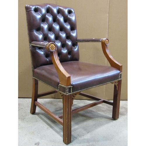 2358 - A reproduction Georgian style open armchair with dark brown faux leather upholstered seat and button... 