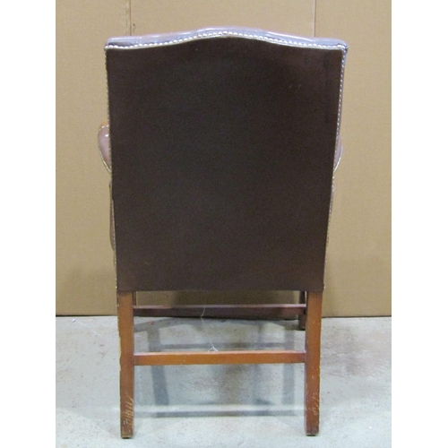 2358 - A reproduction Georgian style open armchair with dark brown faux leather upholstered seat and button... 