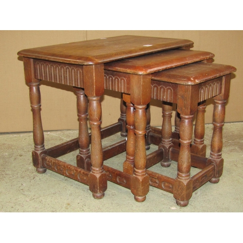 2365 - A nest of three oak graduated occasional tables in the old English style, outer table 61 cm wide x 3... 