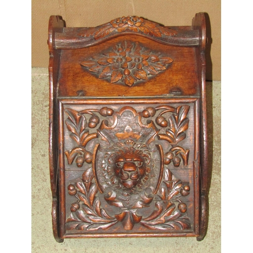 2366 - A Victorian gothic oak coal scuttle with carved handle and lid with lions mask, acorn and oak leaf d... 