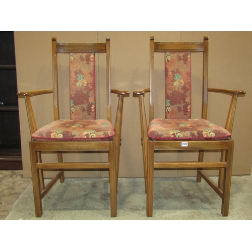 2372 - A pair of Ercol stained elm and beechwood open elbow chairs, with upholstered seats and back splats