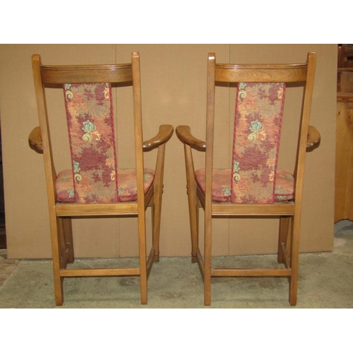 2372 - A pair of Ercol stained elm and beechwood open elbow chairs, with upholstered seats and back splats