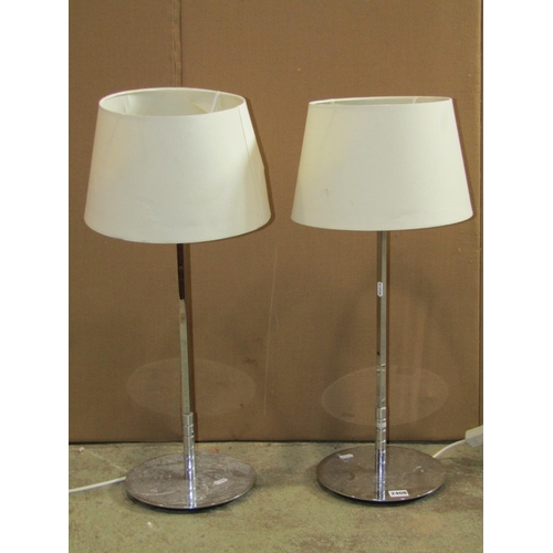 2408 - A pair of contemporary art deco style chrome table lamps with weighted disc bases