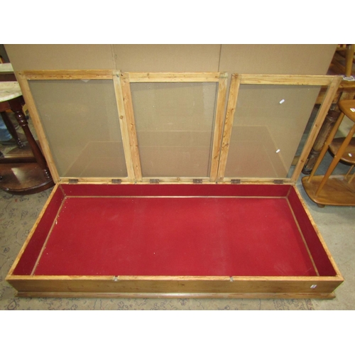 2413 - A vintage stripped pine counter top display case of rectangular form, enclosed by three glazed hinge... 