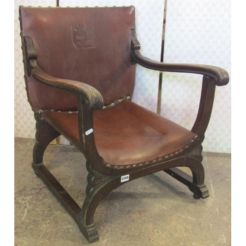 2566 - 1930s oak X framed fireside chair with hide upholstered seats and back