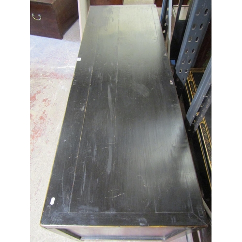 2570 - A Chinese hardwood side board enclosed by an arrangement of doors with central drawers with ebonised... 