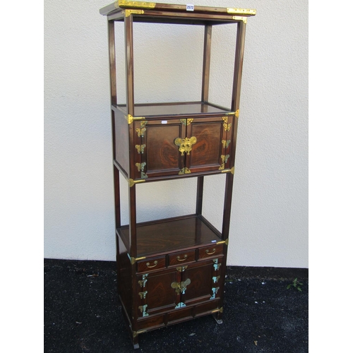 2572 - A Korean open hard wood watnot with overlay brass detail, the upper section with panelled doors and ... 