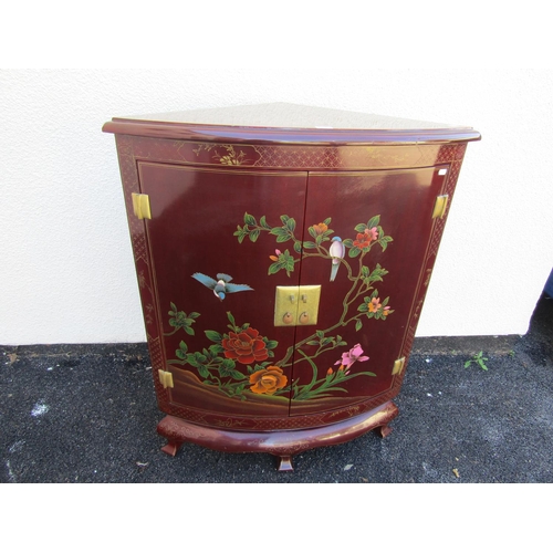 2573 - A Chinese floorstanding corner cupboard enclosed by two doors with painted bird and floral detail an... 