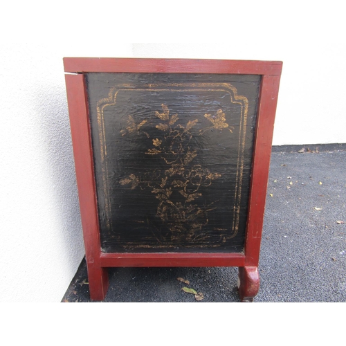 2576 - A Chinese red lacquered cabinet enclosed by cupboards and drawers with carved and painted detail wit... 