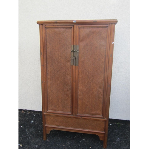 2579 - A Chinese ashwood hanging cupboard, the doors with woven straw work finish over a single frieze draw... 