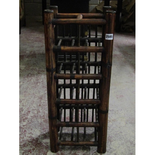 2585 - A Chinese wine rack to hold ten bottles and a red lacquered three tier container