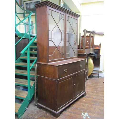 2653 - A late Georgian mahogany secretaire bookcase, enclosed by two panelled doors, the secretaire with fi... 