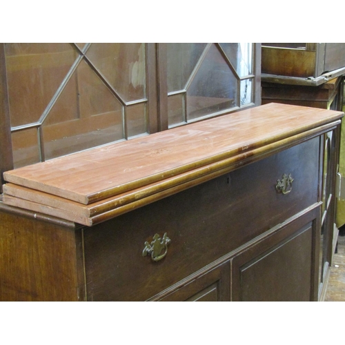 2653 - A late Georgian mahogany secretaire bookcase, enclosed by two panelled doors, the secretaire with fi... 