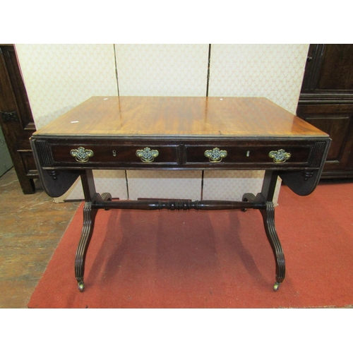 2658 - A Regency mahogany sofa table with rosewood crossbanding, with two frieze drawers and an open stretc... 